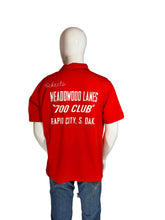 Load image into Gallery viewer, Red shirt with text on a mannequin against a plain wall