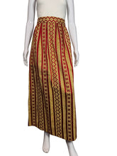 Load image into Gallery viewer, Mannequins holding a patterned fabric against a plain wall.