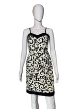 Load image into Gallery viewer, Black and white patterned dress on a mannequin against a plain background