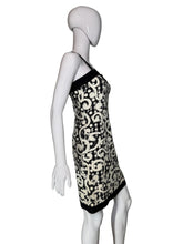 Load image into Gallery viewer, Black and white patterned dress on a mannequin against a plain background