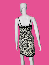 Load image into Gallery viewer, Mannequin wearing a black and white patterned dress on a plain background