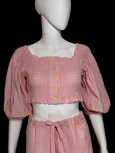 Load image into Gallery viewer, Mannequin wearing a pink smocked top with yellow buttons and matching skirt against a plain background