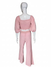 Load image into Gallery viewer, Mannequin wearing a pink outfit with a white top and pants against a plain wall.