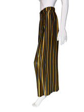 Load image into Gallery viewer, Black and yellow striped pants on mannequins with a neutral background