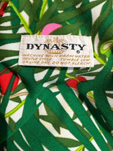 Load image into Gallery viewer, Fabric with a tropical leaf pattern and a Dynasty label.