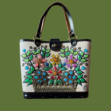 Load image into Gallery viewer, Hand-painted floral design on a handbag against a gray background