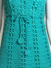 Load image into Gallery viewer, Close-up of a teal crocheted item with a button on a white background