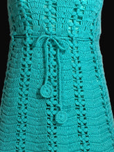 Load image into Gallery viewer, Close-up of a teal crocheted item with a button on a white background