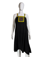 Load image into Gallery viewer, Black dress with colorful embroidery on a mannequin against a white wall.