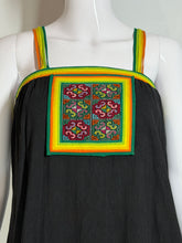 Load image into Gallery viewer, Black garment with colorful embroidery on a mannequin against a white background.