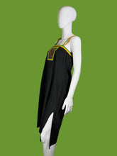 Load image into Gallery viewer, Mannequin wearing a black outfit with green and yellow accents