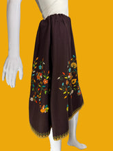 Load image into Gallery viewer, Brown skirt with floral embroidery on a mannequin against a white background.