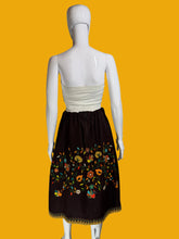 Load image into Gallery viewer, Mannequin wearing a white top and brown skirt with floral embroidery against a plain wall.