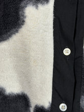 Load image into Gallery viewer, Close-up of a black and white textured fabric with faint orange spots.