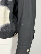 Load image into Gallery viewer, Close-up of a black sleeve with a light spot on it