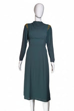 Load image into Gallery viewer, Mannequin wearing a teal dress with gold accents against a white wall.