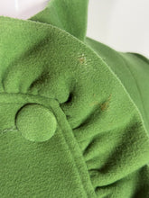 Load image into Gallery viewer, Close-up of a green fabric with a button showing some stains