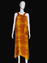 Load image into Gallery viewer, Mannequin wearing an orange patterned dress against a plain wall.