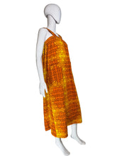 Load image into Gallery viewer, Mannequin wearing an orange patterned dress against a white wall.