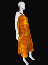 Load image into Gallery viewer, Mannequin wearing an orange patterned dress against a white wall.