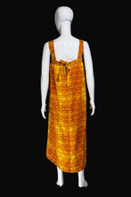 Load image into Gallery viewer, Mannequin wearing an orange patterned dress against a plain wall.