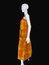 Load image into Gallery viewer, Mannequin wearing an orange and yellow patterned dress on a white background.