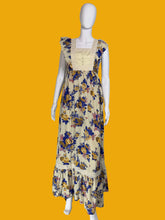 Load image into Gallery viewer, Floral dress on a mannequin against a plain wall.
