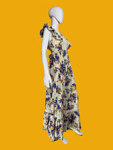 Load image into Gallery viewer, Floral dress on a mannequin against a plain wall.