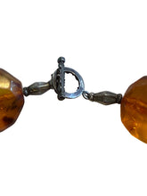 Load image into Gallery viewer, Close-up of amber beads with a silver clasp