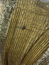 Load image into Gallery viewer, close up of the damage on the gold fabric
