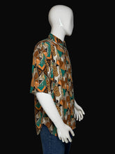 Load image into Gallery viewer, Mannequin wearing a patterned shirt with a brown and teal geometric design