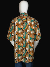 Load image into Gallery viewer, Mannequin wearing a patterned shirt with a brown and teal geometric design