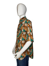 Load image into Gallery viewer, Mannequin wearing a patterned shirt with a brown and teal geometric design