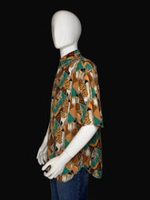 Load image into Gallery viewer, Mannequin wearing a patterned shirt with a brown and teal geometric design