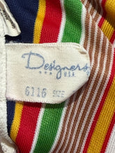 Load image into Gallery viewer, Close-up of a colorful striped fabric with a brand label that reads "Designers USA"