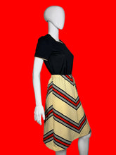 Load image into Gallery viewer, Mannequin wearing a set featuring a black top and a chevron skirt