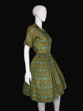 Load image into Gallery viewer, Green and blue patterned dress on a mannequin