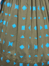 Load image into Gallery viewer, Green fabric with blue geometric patterns