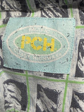 Load image into Gallery viewer, Textile patch with 'PCH' logo on a patterned background