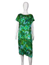 Load image into Gallery viewer, Green patterned dress on a white mannequin against a plain wall.