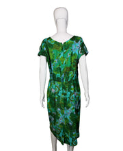 Load image into Gallery viewer, Green patterned dress on a white mannequin against a plain wall.