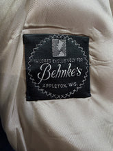 Load image into Gallery viewer, A close-up of a black sewn-in brand label on a light beige fabric. The label reads 'Behmke's' with 'Appletons, Wis.