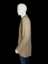 Load image into Gallery viewer, A beige long-sleeve jacket displayed on a white mannequin.