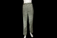 Load image into Gallery viewer, A pair of trousers with a plaid pattern, displayed on a white mannequin leg against a white wall.