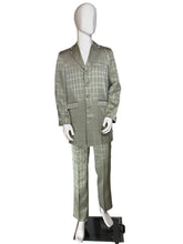 Load image into Gallery viewer, A two-piece men's suit in silvery sage green and gray windowpane plaid pattern, displayed on a white mannequin. The suit includes a single-breasted jacket with notch lapels and a matching pair of trousers.