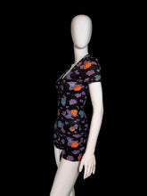 Load image into Gallery viewer, A black short-sleeve romper in side profile view