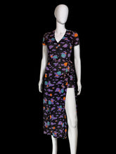 Load image into Gallery viewer, A short-sleeve romper with a wrap skirt in a multicolor cloud pattern on a black background, displayed on a white mannequin,