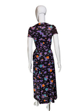 Load image into Gallery viewer, Back view of a romper/wrap skirt set with a colorful abstract pattern of purple, orange, and teal shapes, displayed on a white mannequin