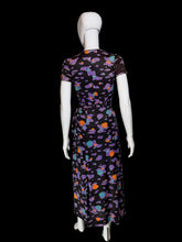 Load image into Gallery viewer, Back view of a romper/wrap skirt set with a colorful abstract pattern of purple, orange, and teal shapes, displayed on a white mannequin