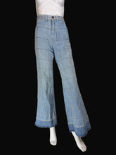 Load image into Gallery viewer, Light blue wide-leg denim jeans displayed on a white mannequin